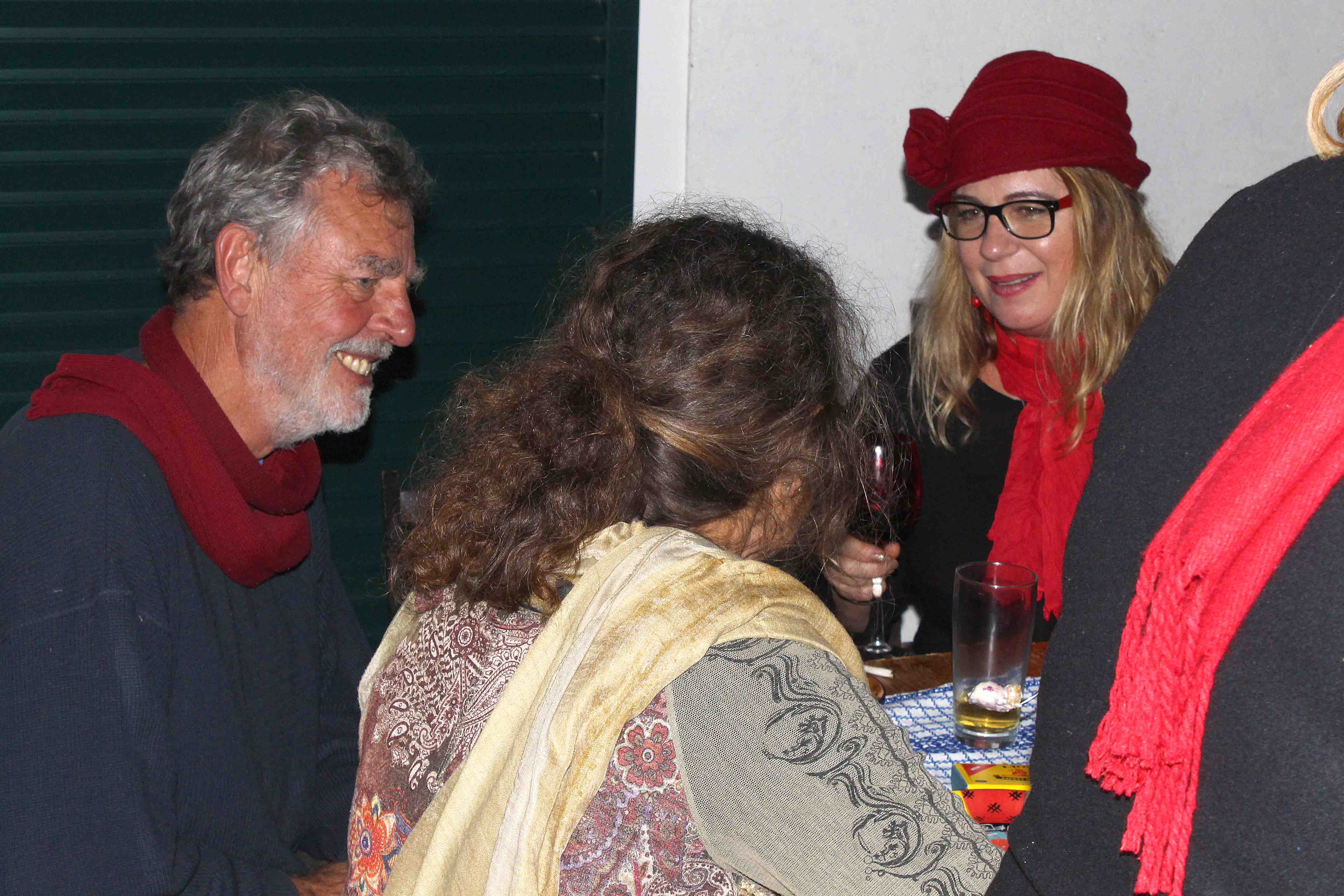 Guests eating and chatting at the table.