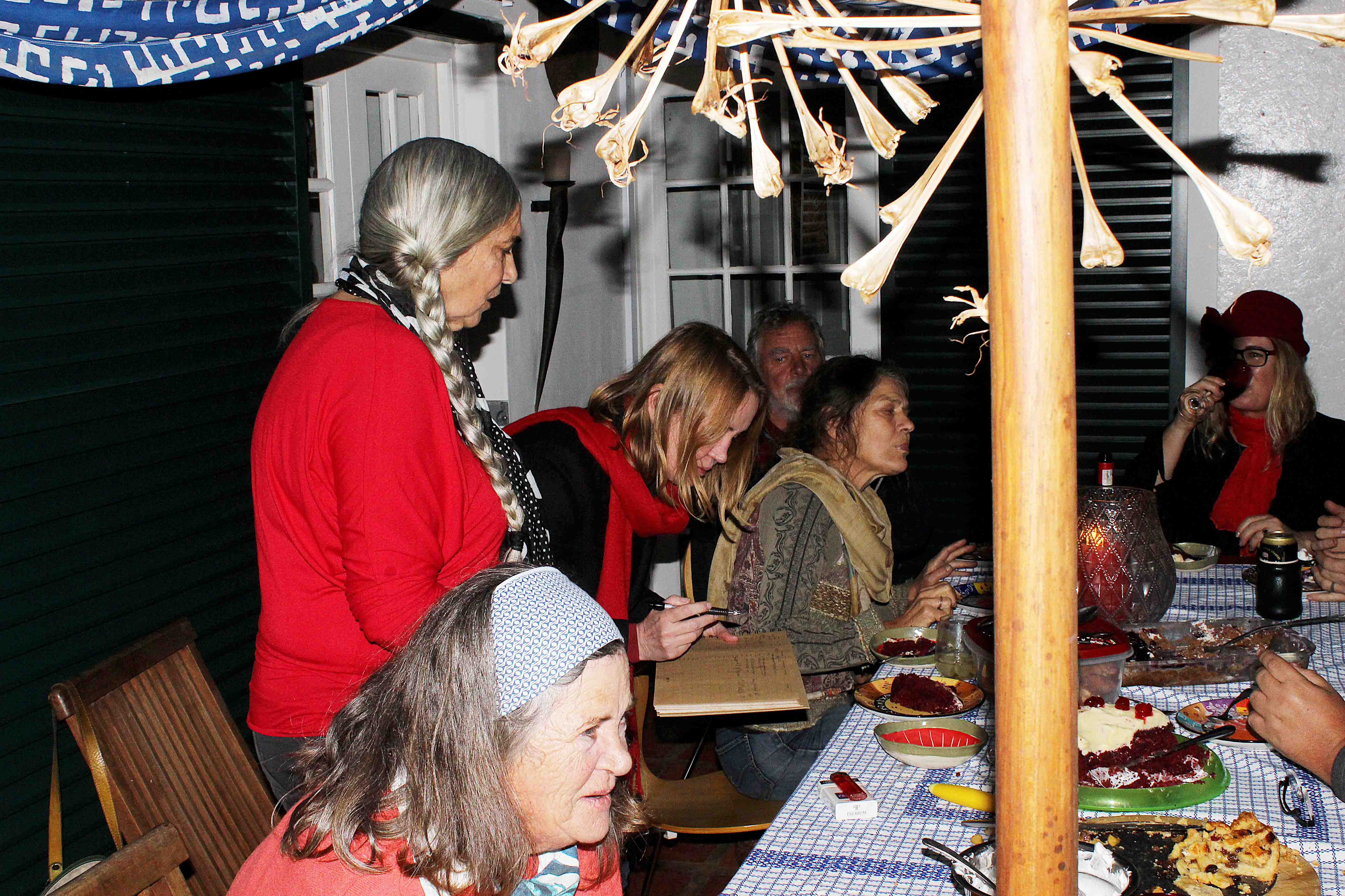 Guests eating and chatting at the table.