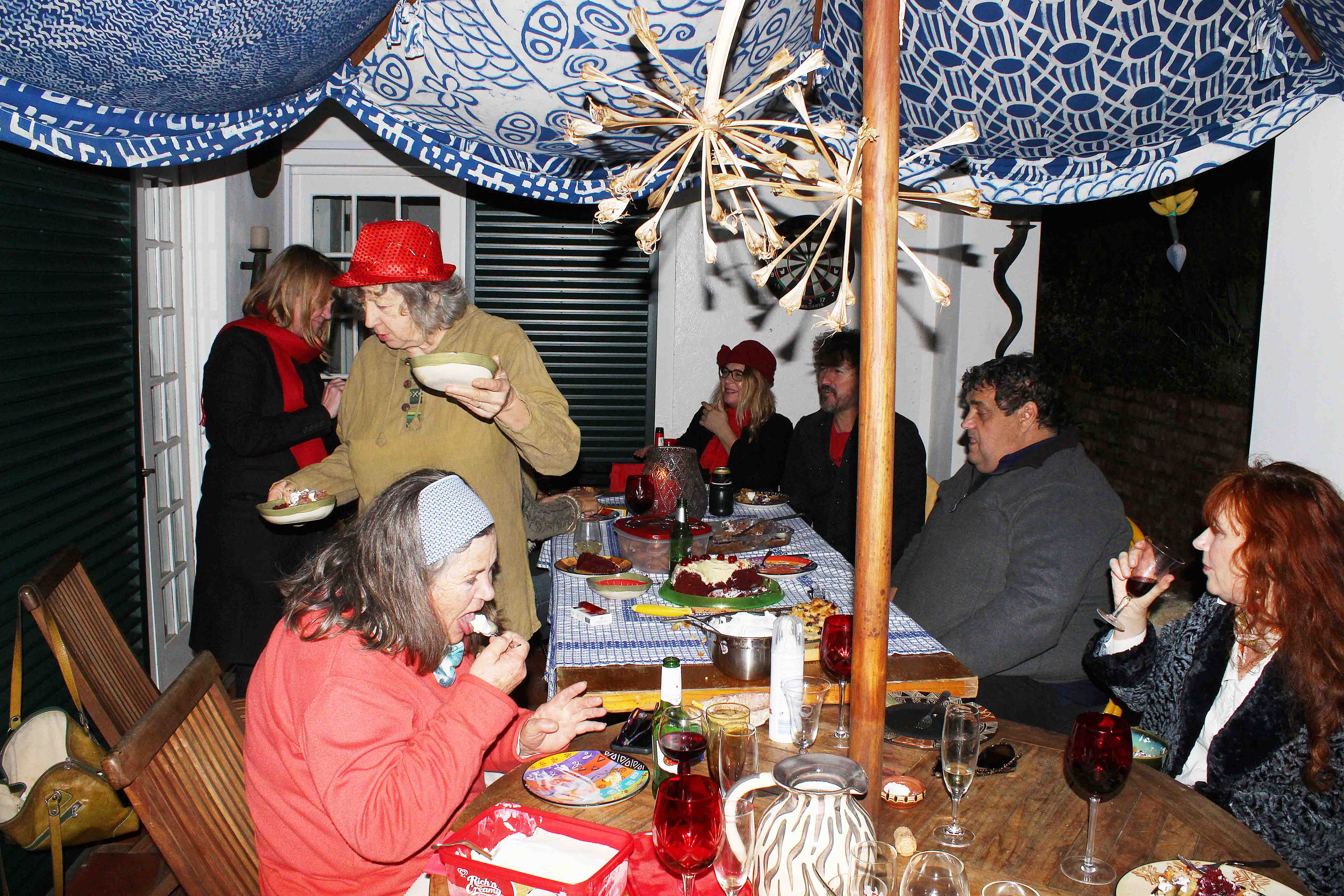 Guests eating and chatting at the table.