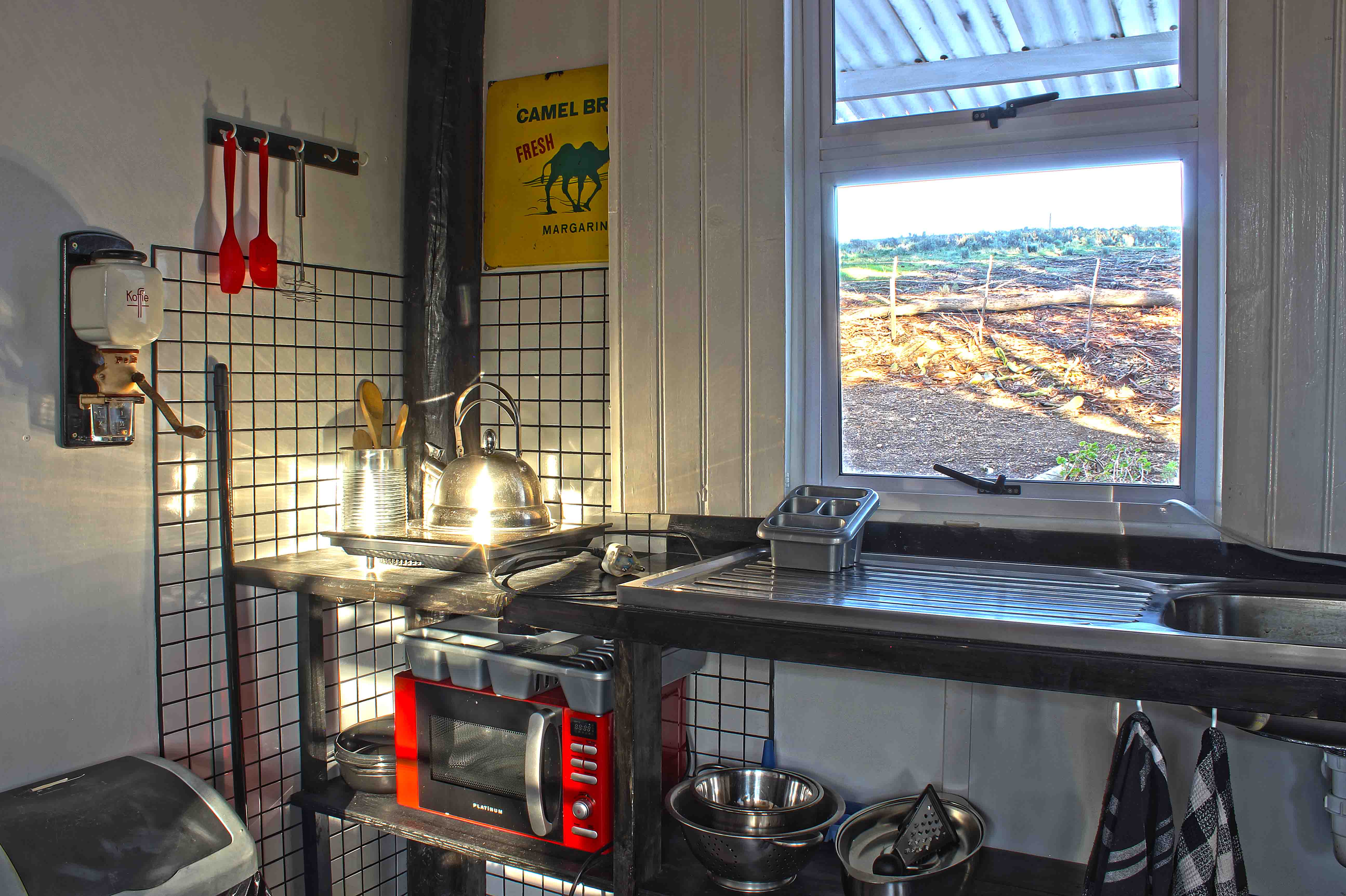 The kitchen of the guest house, with a snappy chef and microwave.